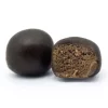 Deux boules de résine noire, l'une entière, l'autre coupée révélant une texture intérieure brun clair.