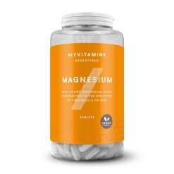 Flacon transparent contenant des comprimés blancs, avec une étiquette orange portant l'inscription "MAGNESIUM" et mentionnant une teneur de 300 mg de magnésium. Le flacon est marqué "Vegan Friendly".